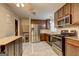 Modern kitchen featuring stainless steel appliances, dark cabinets, and granite countertops for a stylish cooking space at 77 Crystal River Dr, Riverdale, GA 30274