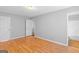 Bright bedroom with hardwood floors features a door to an adjacent bathroom at 111 Hamilton Rd, Peachtree City, GA 30269