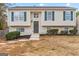 Charming two-story home with green shutters, a welcoming front door, and landscaped front yard at 111 Hamilton Rd, Peachtree City, GA 30269