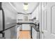 Eat-in kitchen with white cabinets, stainless steel appliances and tile floor at 111 Hamilton Rd, Peachtree City, GA 30269