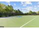 Community basketball court featuring well-maintained surfaces, surrounded by lush trees, perfect for outdoor games at 5260 Sherwood Way, Cumming, GA 30040