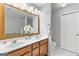 Clean bathroom with double sinks, a large mirror, and a separate toilet area, providing ample space at 5260 Sherwood Way, Cumming, GA 30040