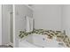 Bathroom featuring a luxurious soaking tub with tile surround, complemented by a nearby glass-enclosed shower at 5260 Sherwood Way, Cumming, GA 30040