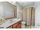 Simple bathroom featuring a sink, toilet, and shower with a striped curtain at 5260 Sherwood Way, Cumming, GA 30040