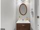 Bathroom features a vanity with a round mirror, decorative accents, and a clean, modern design at 5260 Sherwood Way, Cumming, GA 30040