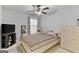 Minimalist bedroom with a simple bed, dresser, TV, and neutral color scheme, creating a calming space at 5260 Sherwood Way, Cumming, GA 30040