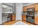 Compact kitchen layout, features a gas range, ample storage space, and adjacent breakfast bar at 5260 Sherwood Way, Cumming, GA 30040