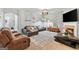Well-lit living room with a decorative fireplace, comfy seating, and seamless transitions to other living spaces at 5260 Sherwood Way, Cumming, GA 30040