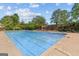 A large community pool is surrounded by a brick fence and mature trees, offering residents a refreshing escape at 5260 Sherwood Way, Cumming, GA 30040