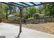 Backyard featuring a concrete patio, a pergola, a fire pit, wood fencing, and lush trees at 2638 Lake Manor Cir, Duluth, GA 30096
