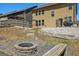Backyard featuring a stone fire pit, wooden benches, a pergola, and steps up to the home at 2638 Lake Manor Cir, Duluth, GA 30096