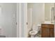 View of a half bathroom features a toilet and vanity with neutral colored walls and tile flooring at 2638 Lake Manor Cir, Duluth, GA 30096