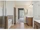 Bathroom featuring dual sinks, tile flooring, soaking tub, and glass enclosed shower at 2638 Lake Manor Cir, Duluth, GA 30096