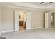 Spacious carpeted bedroom with a ceiling fan, natural light and an ensuite bathroom at 2638 Lake Manor Cir, Duluth, GA 30096