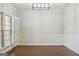 Light-filled dining room with decorative wainscoting, plantation shutters, and wood floors at 2638 Lake Manor Cir, Duluth, GA 30096