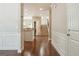 Inviting entryway with hardwood floors, elegant wainscoting, and open staircase leading upstairs at 2638 Lake Manor Cir, Duluth, GA 30096