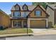 Charming two-story home features brick facade, dormer windows, and a two-car garage at 2638 Lake Manor Cir, Duluth, GA 30096