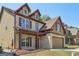 Brick home featuring an attached 2 car garage, covered porch, and well manicured lawn at 2638 Lake Manor Cir, Duluth, GA 30096