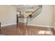 Open concept living room showcases hardwood floors, a staircase, and access to the kitchen at 2638 Lake Manor Cir, Duluth, GA 30096