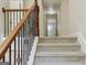 Carpeted staircase with decorative wood railing leads to the upper level of the home at 2638 Lake Manor Cir, Duluth, GA 30096