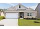 Charming single-Gathering home featuring a two-car garage and professionally landscaped front yard at 289 Limestone Circle, Conyers, GA 30013