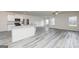 Open-concept kitchen with gray floors, white cabinets, and stainless steel appliances at 289 Limestone Circle, Conyers, GA 30013
