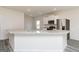 Bright, open kitchen features a granite-topped island, stainless steel appliances, and modern cabinets at 289 Limestone Circle, Conyers, GA 30013
