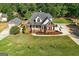 Aerial view of a brick home with manicured lawn, detached garage, and mature trees at 1108 Sequoia Trl, Mcdonough, GA 30252