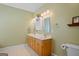 Bathroom featuring double sinks, warm color tones, and vanity cabinet with storage at 1108 Sequoia Trl, Mcdonough, GA 30252