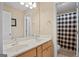 Bright bathroom offers a double vanity with decorative countertop and a shower with patterned curtains at 1108 Sequoia Trl, Mcdonough, GA 30252