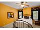 Comfortable bedroom features yellow walls, striking floral valances, and a decorative ceiling fan at 1108 Sequoia Trl, Mcdonough, GA 30252