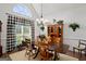 Traditional dining room with large window, chandelier, and wooden table and chairs at 1108 Sequoia Trl, Mcdonough, GA 30252