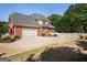 Well-maintained brick home with a two-car garage, complemented by a white picket fence and an expansive driveway at 1108 Sequoia Trl, Mcdonough, GA 30252