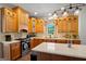 Bright kitchen featuring wooden cabinets, stainless steel appliances, and a kitchen island at 1108 Sequoia Trl, Mcdonough, GA 30252