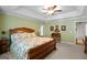 This is a view of the the other side of the main bedroom with tray ceiling, ceiling fan, and desk area at 1108 Sequoia Trl, Mcdonough, GA 30252