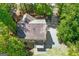 Aerial view of a home showcasing its roof, driveway, surrounding greenery, deck, and a view of the neighborhood at 9276 Fieldstone Ct, Jonesboro, GA 30236