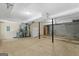 Basement area featuring concrete flooring, white fridge, and utility connections at 9276 Fieldstone Ct, Jonesboro, GA 30236