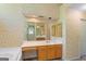 Bathroom with wood vanity, neutral counters, and a large mirror to reflect natural light at 9276 Fieldstone Ct, Jonesboro, GA 30236