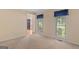 Cozy bedroom featuring carpet and a view of the front yard with natural light at 9276 Fieldstone Ct, Jonesboro, GA 30236