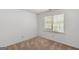 Bedroom with bright walls, soft carpet, and window letting in sunlight, ideal for relaxation at 9276 Fieldstone Ct, Jonesboro, GA 30236