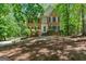 Charming two-story brick home with black shutters, lush landscaping, and a welcoming front entrance at 9276 Fieldstone Ct, Jonesboro, GA 30236