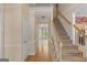 Bright foyer with hardwood floors, staircase, and views into the dining area, creating an inviting entrance at 9276 Fieldstone Ct, Jonesboro, GA 30236