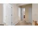 Bright hallway with carpeted floors, white doors, and easy access to a bathroom and other rooms at 9276 Fieldstone Ct, Jonesboro, GA 30236