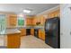 Well-equipped kitchen featuring oak cabinets, modern appliances, granite countertops, and lots of light at 9276 Fieldstone Ct, Jonesboro, GA 30236