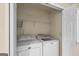 Laundry closet with a full-size Maytag washer and dryer and wire shelving at 9276 Fieldstone Ct, Jonesboro, GA 30236