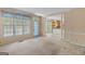 Spacious living room featuring large windows offering plenty of natural light and easy access to other rooms at 9276 Fieldstone Ct, Jonesboro, GA 30236