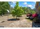 Lush backyard featuring mature trees, garden beds, and a well-maintained lawn at 1154 Ridge Hollow Ln, Lawrenceville, GA 30043