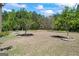 Wide backyard featuring mature trees and a partially maintained lawn at 1154 Ridge Hollow Ln, Lawrenceville, GA 30043