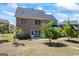 Spacious backyard showcasing a brick two-story home with a door to a small, plain patio at 1154 Ridge Hollow Ln, Lawrenceville, GA 30043