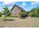 Expansive backyard featuring a brick home, lush greenery, and a well-maintained lawn at 1154 Ridge Hollow Ln, Lawrenceville, GA 30043